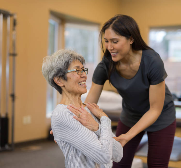 Occupational therapist training aging adult female in one-on-one therapy session