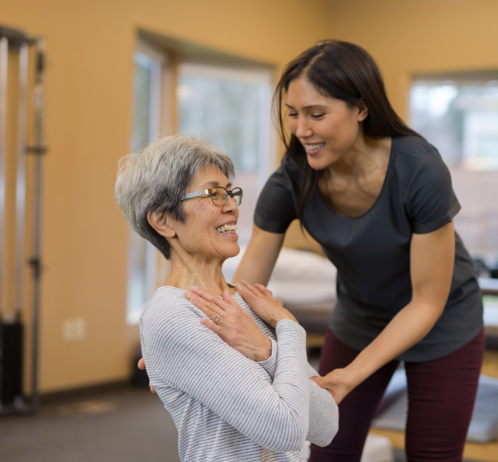 Training aging adult female in one-on-one training session